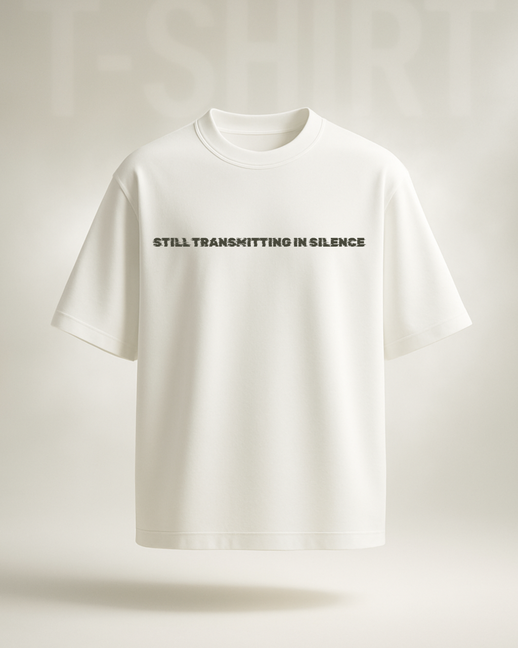 White t-shirt with text 'STILL TRANSMITTING IN SILENCE' on a light gray background